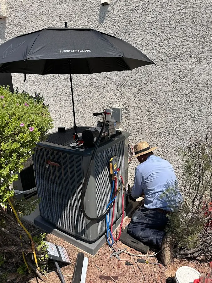 HVAC technician performing outdoor AC maintenance in Cheney