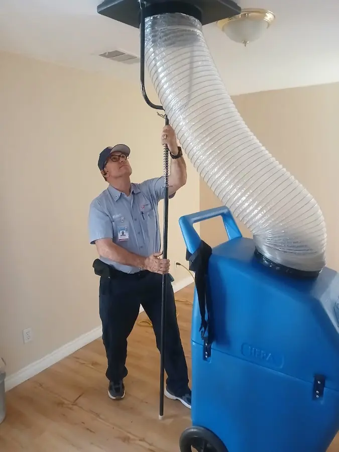 Furnace Tune-Up technician using HEPA equipment in Cheney